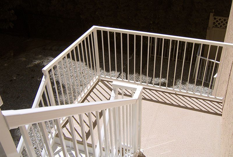 White powder coated aluminum picket deck railing showing clean classic railing design