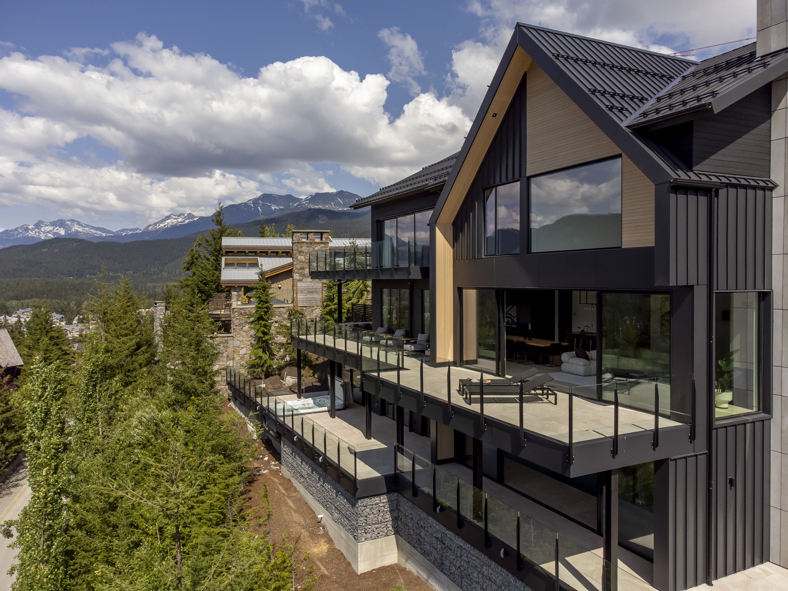 Completed aluminum deck railing installation on residential property showing glass and picket railing systems