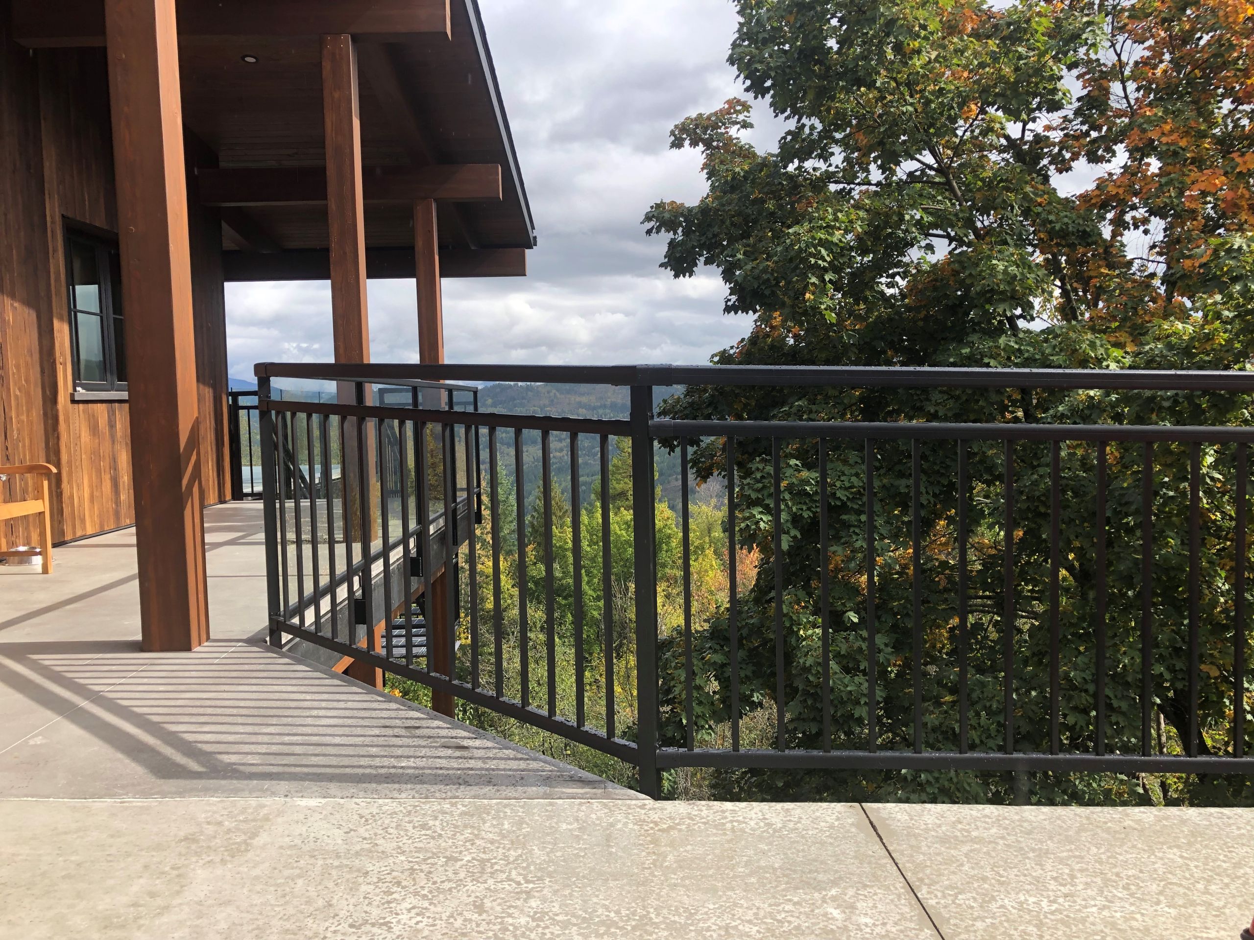 Black powder coated aluminum deck railing installation showing the most popular railing color option