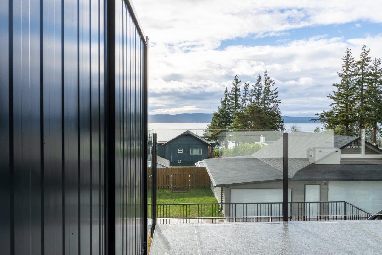 Frameless glass deck railing system showing clear unobstructed views on residential deck installation