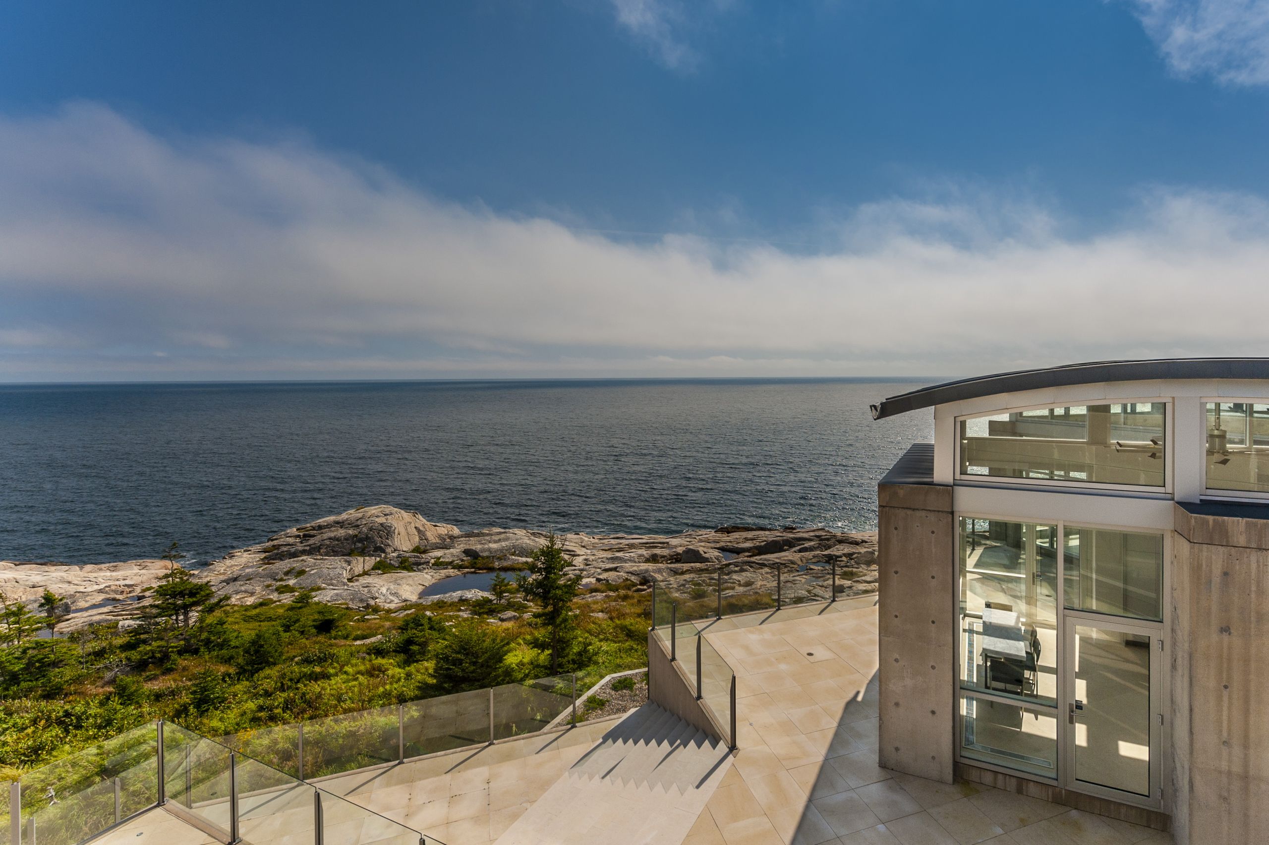 Code-compliant aluminum glass deck railing installed on elevated residential deck meeting building code height requirements